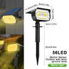 A black motion sensor outdoor wall lamp with a yellow light, mounted on a stake for landscape lighting.