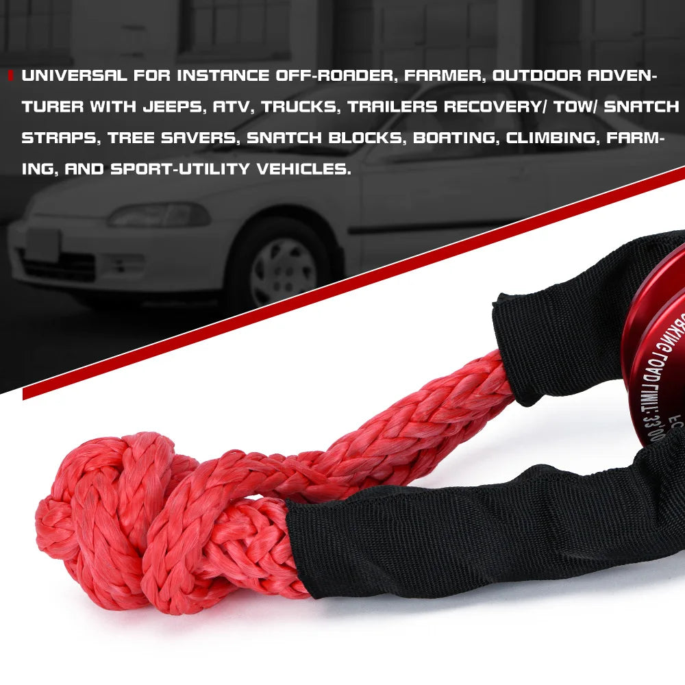 A thick red synthetic recovery shackle strap coiled and bundled with a black sleeve.