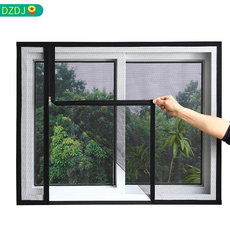 A hand is opening a black framed window with a mesh screen, showing greenery outside.