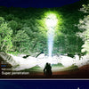 A portable LED flashlight with a zoom function shining a bright beam into the night.