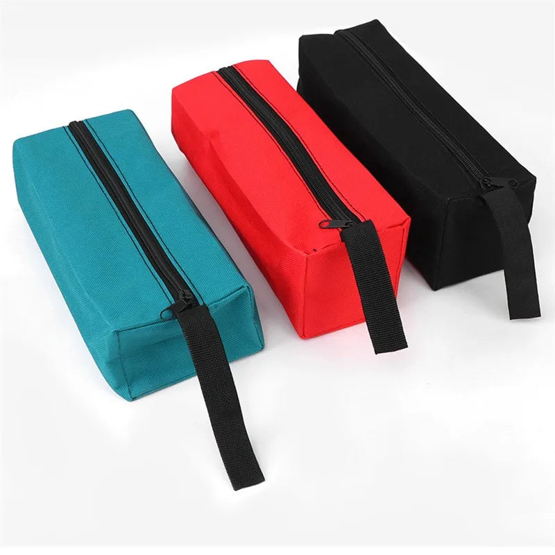 Three Oxford cloth hand-held storage bags in teal, red, and black.