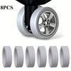 Eight protective luggage wheels shown in various views and a mounted wheel.