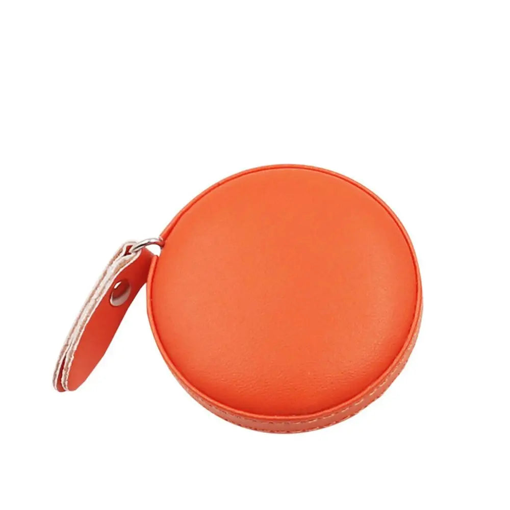 Orange retractable dual scale measuring tape with a leather strap.
