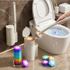 A white toilet brush set featuring a wall-mounted brush, a stand, and several small cleaning tools on a marble countertop.