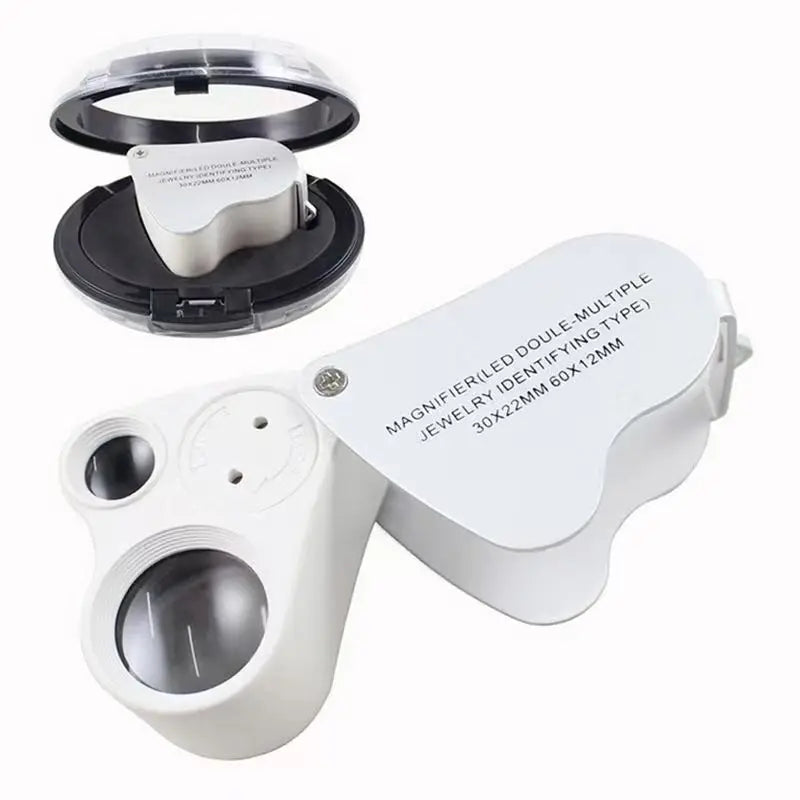 A white foldable LED magnifier is shown with its protective cover removed, displaying the lens for jewelry and coin inspectio