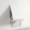 A roll of white 3D stereo concave-convex wall decal sticker is mounted on a white paneled wall.