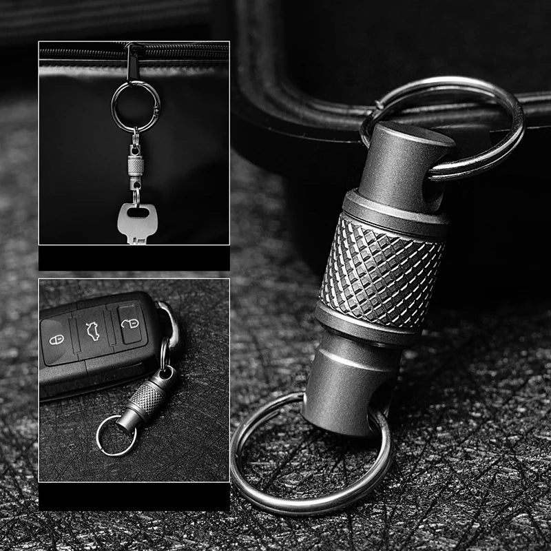 A close-up photo of a titanium alloy rotating keychain key holder attached to a black leather surface.