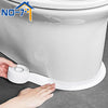 Une main applique un rouleau de ruban adhésif imperméable blanc à la base d'une cuvette de toilette blanche.