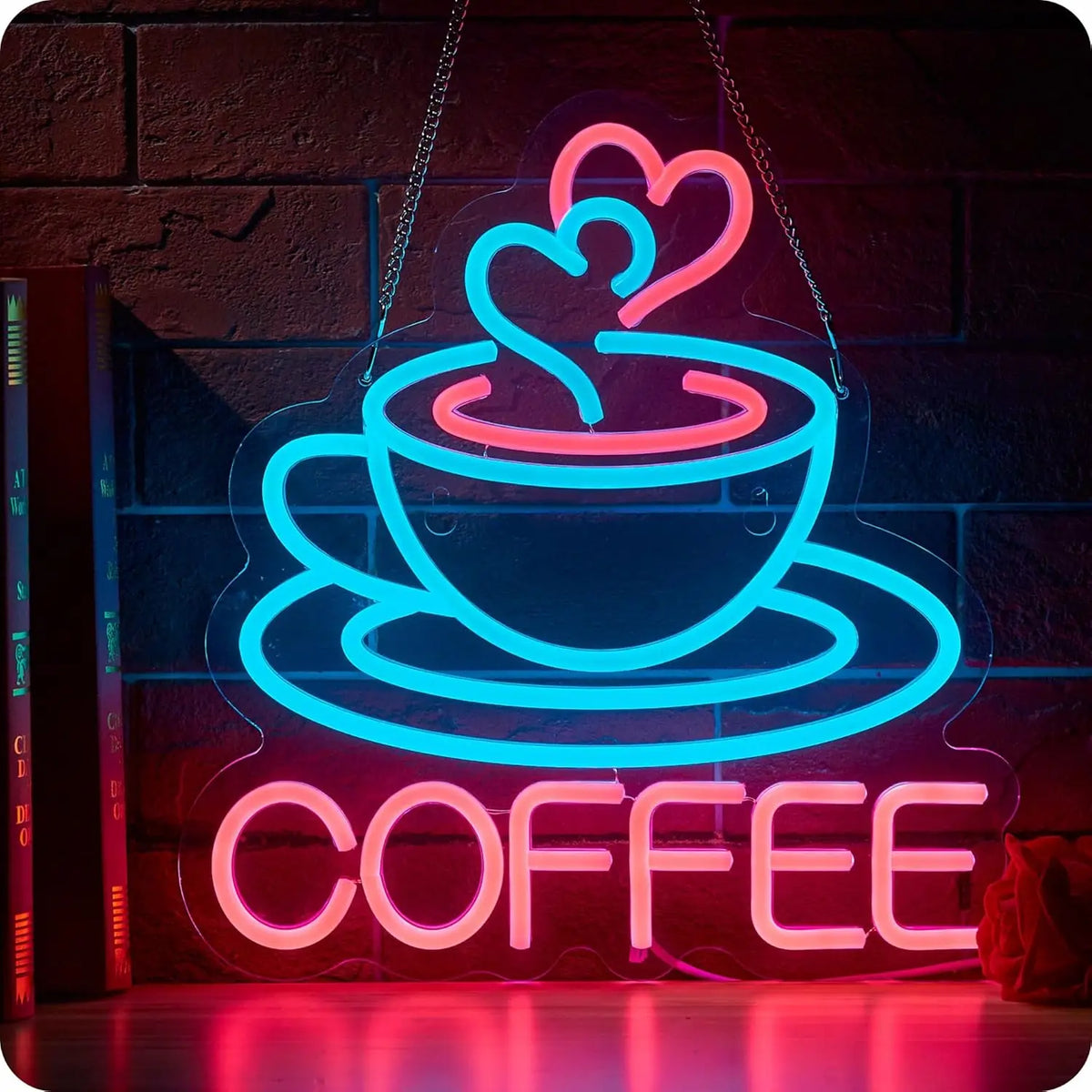 Neon sign depicting a steaming cup of coffee in bright blue and pink outlines on a brick wall.