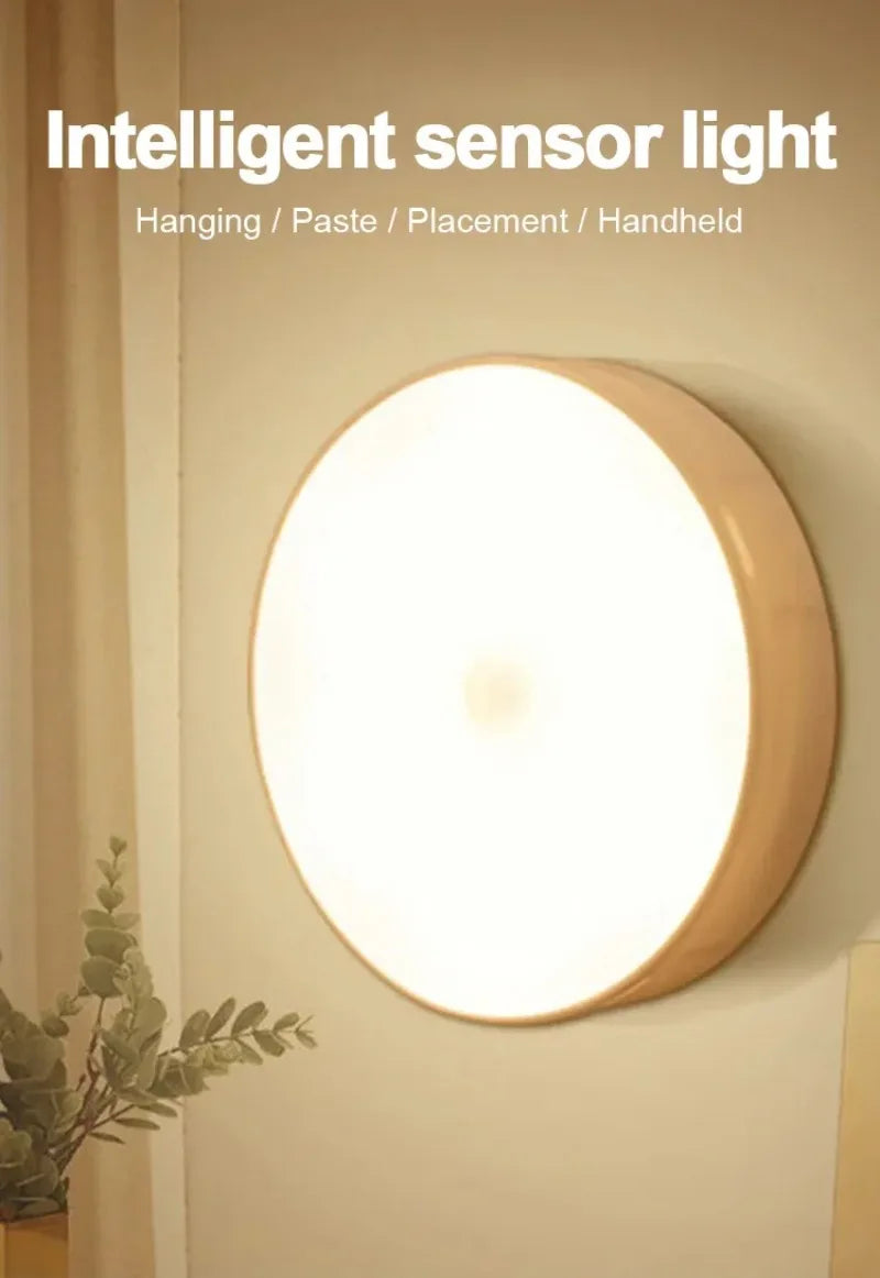 A round, warm-toned intelligent sensor light fixture mounted on a wall.