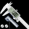 A precision digital caliper with a metal body and a ruler scale is shown against a black background.