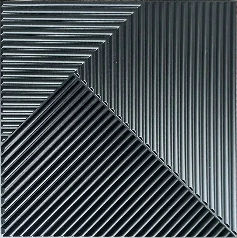 A close-up view of black, ribbed 3D diamond PVC wall panels arranged in a sharp diagonal pattern.