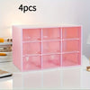 A pink multi-compartment drawer organizer with four sections is displayed on a white surface.