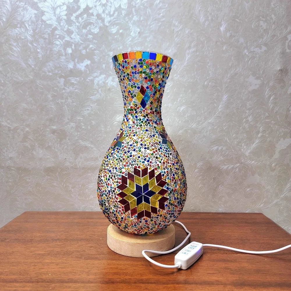 Jarrón o lámpara de vidrio colorido y entrelazado con textura sobre una mesa de madera.