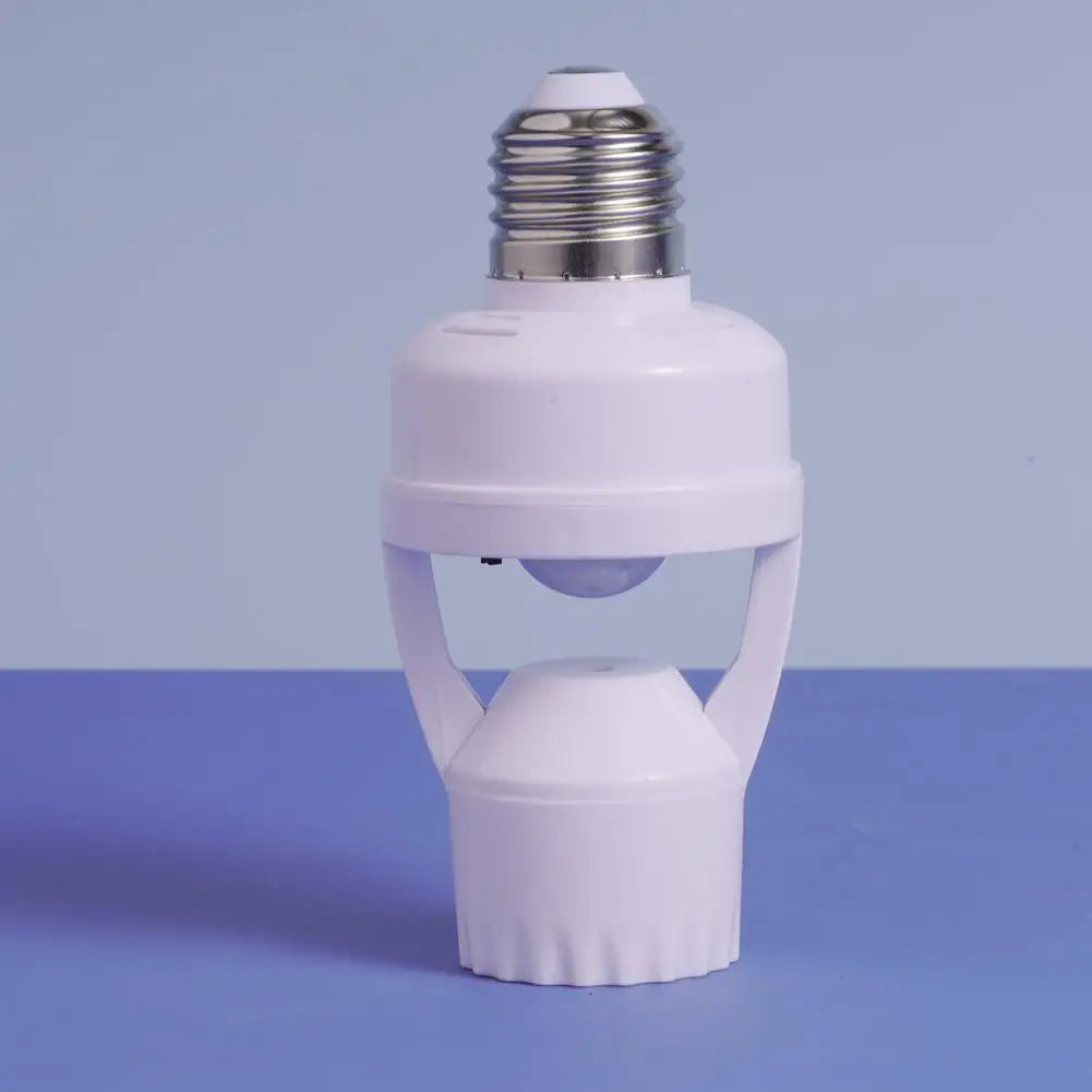 A white light bulb adapter with a screw base and a housing, set against a blue background.
