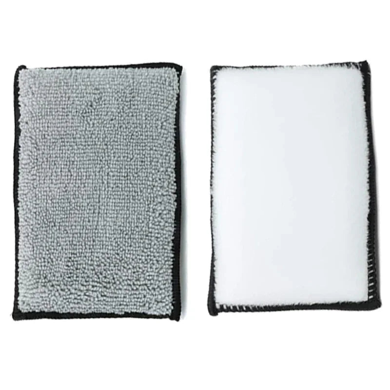 A pair of gray and white microfiber detailing sponges with black edges.