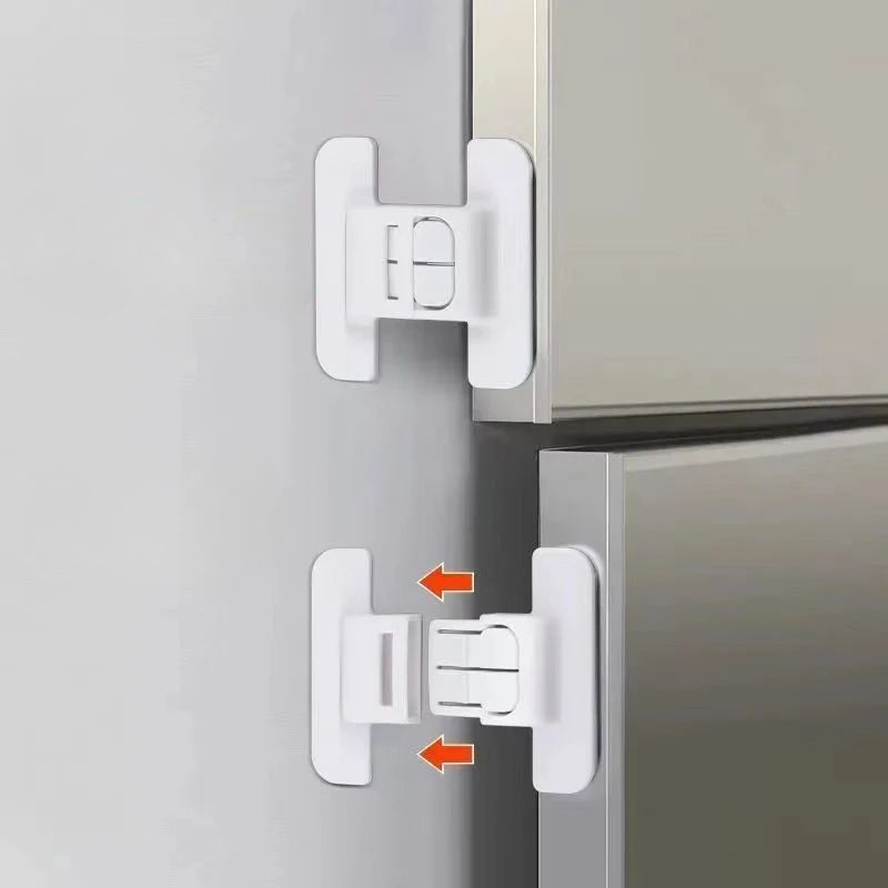 White baby safety refrigerator door locks installed on a silver cabinet door.