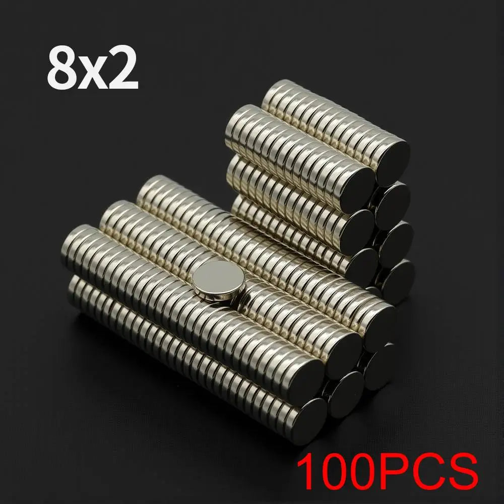 A pile of 100 fridge magnets, featuring 8 sets of 2 magnets each, with a silver finish.