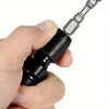 A hand is holding a black impact wrench adapter and socket extension bit holder with a metallic shaft.