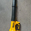 A yellow cordless leaf blower with a black and yellow battery is shown against a gray background.