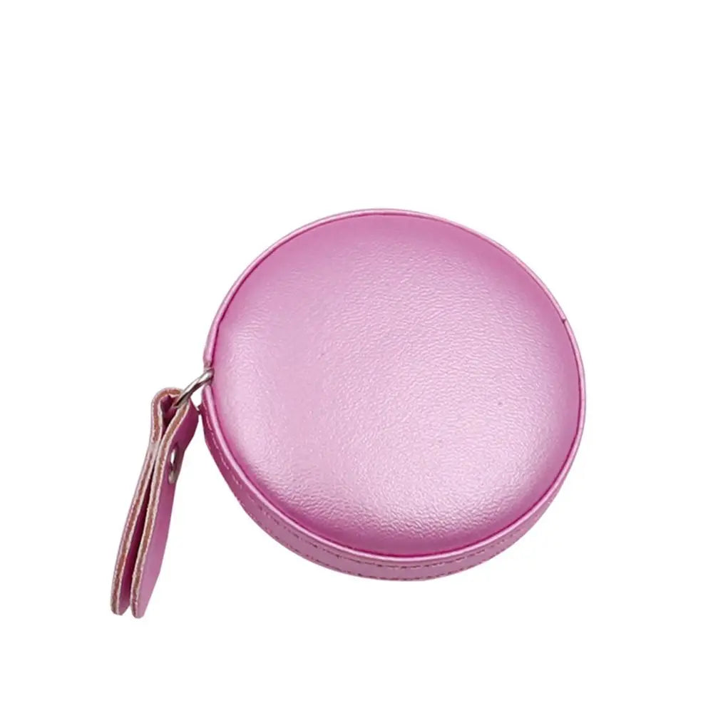 A pink retractable dual scale measuring tape is shown against a white background.
