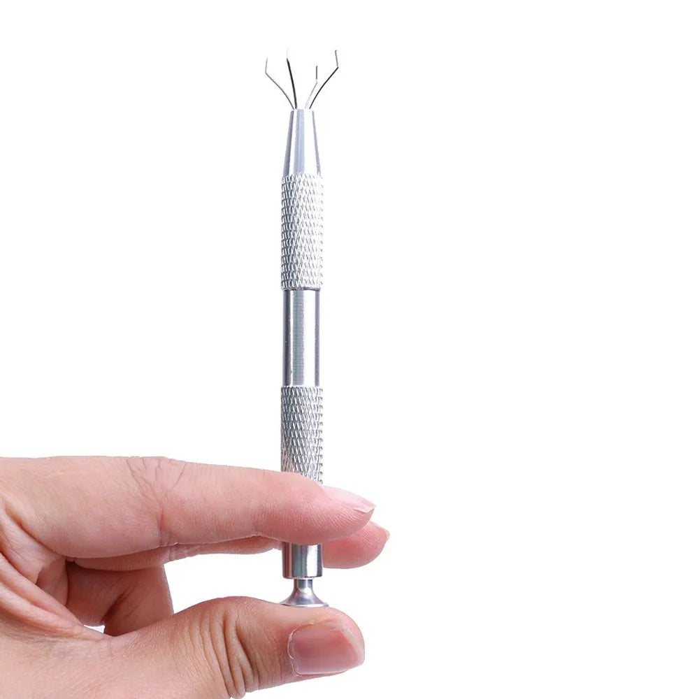 A hand holds a silver precision 4-prong gem and small parts grabber tool.