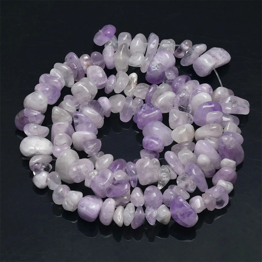 A circular arrangement of translucent lavender and white agate beads for jewelry making