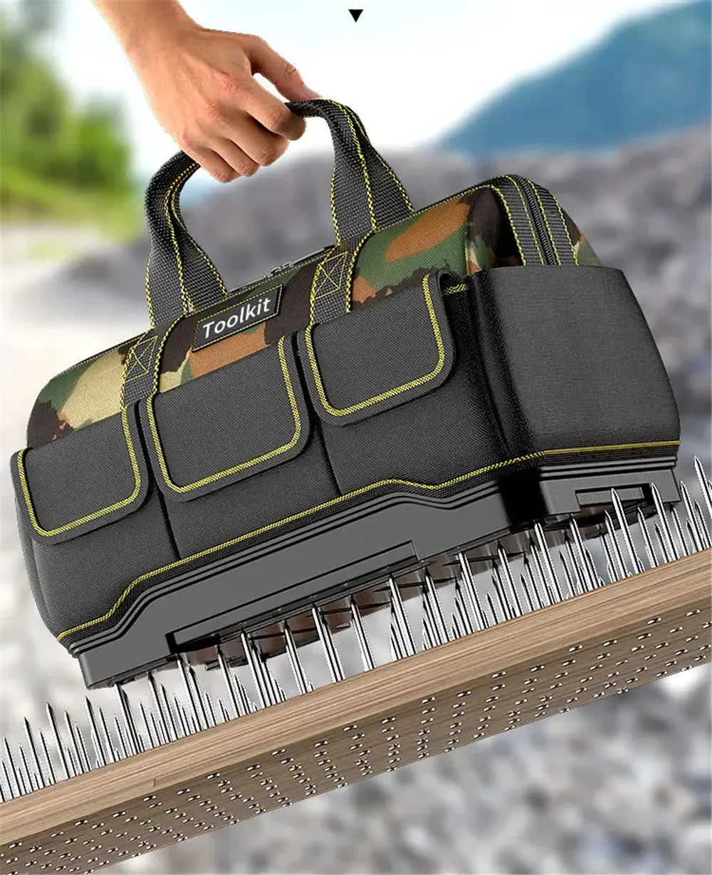 A hand is holding a durable camouflage toolkit with black and olive green fabric on a wooden surface.