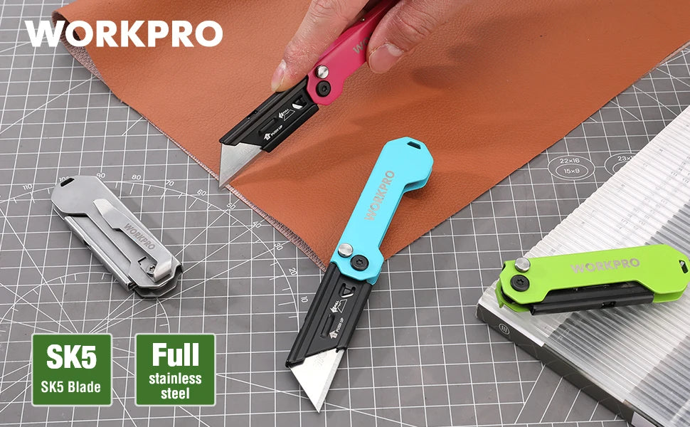 A set of three WorkPro folding utility knives with stainless steel blades shown on a brown paper background.