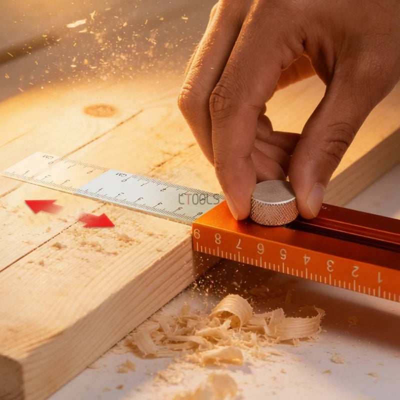 A hand is using an extendable multifunction scribing level ruler to measure wood, creating sawdust.