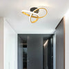Modern LED ceiling light fixture with a gold and white ring design mounted on a white ceiling.