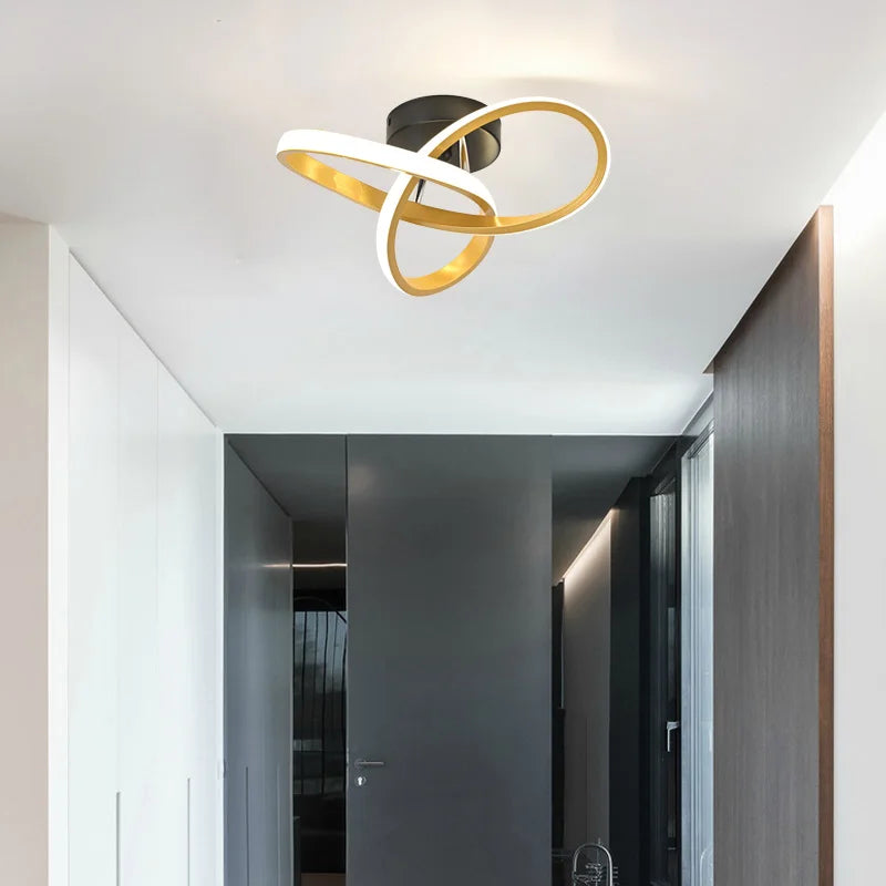 Modern LED ceiling light fixture with a gold and white ring design mounted on a white ceiling.