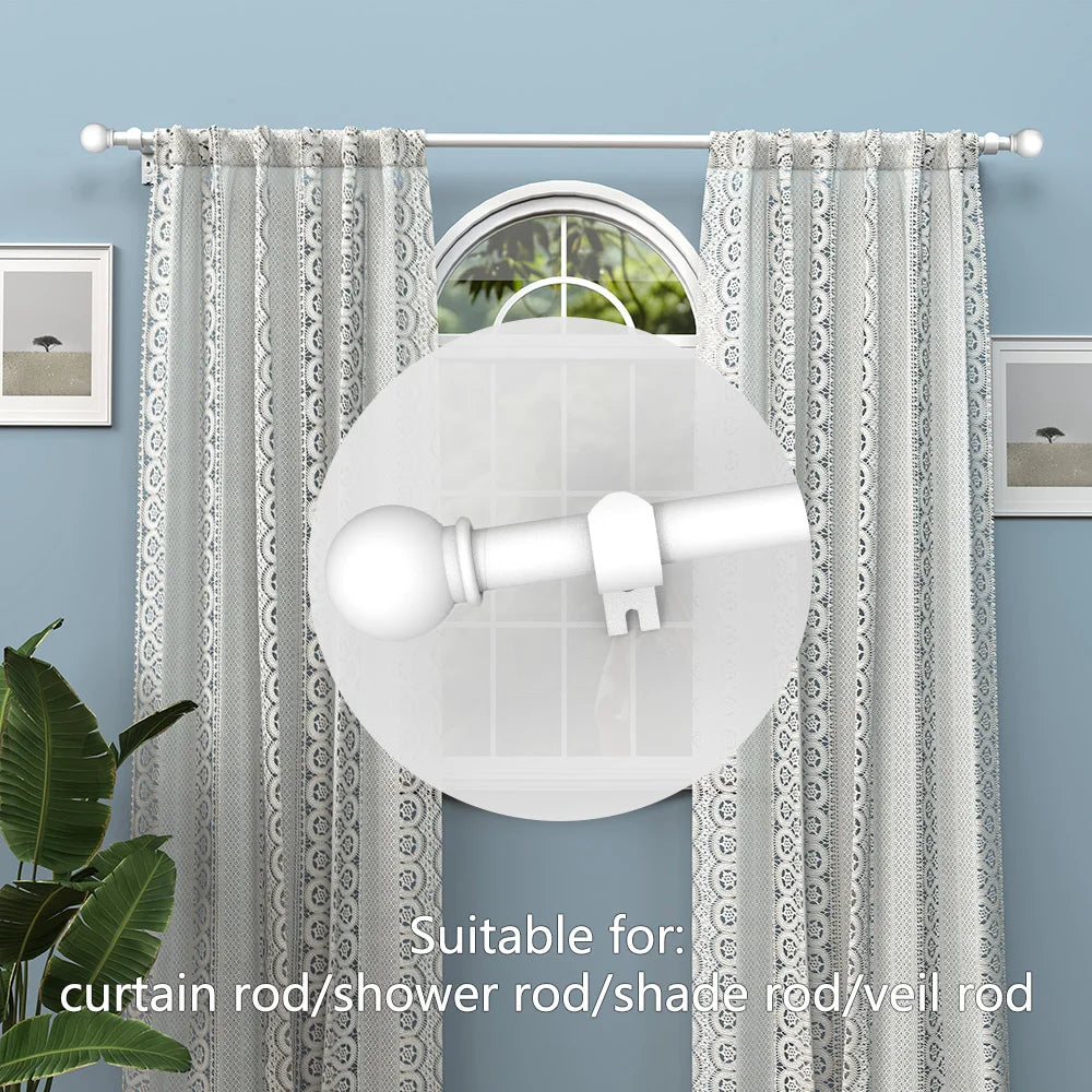 A white iron spliced curtain rod is shown hanging against a light blue wall with sheer patterned curtains.