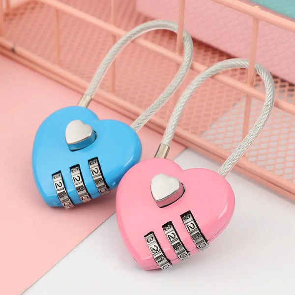 A pink heart-shaped combination lock with a white cord, resting on a pink background.