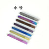 A collection of titanium clip tweezers in various shades of gray and purple are displayed against a white background.