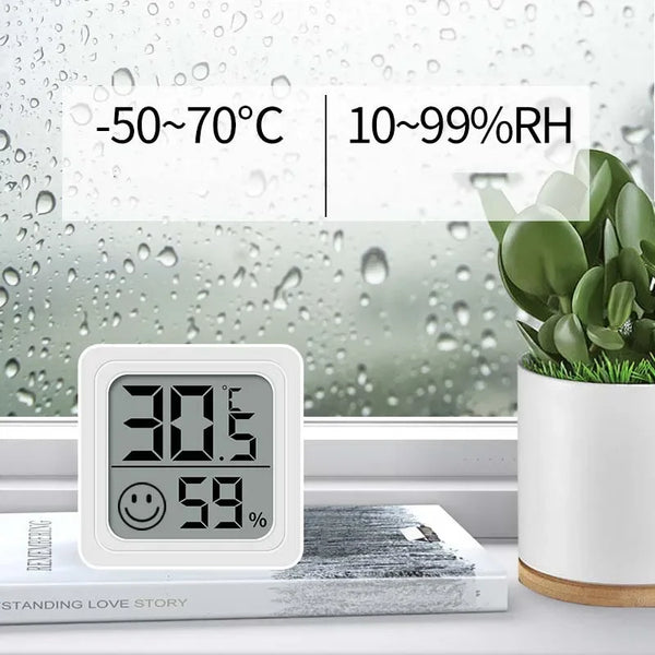 A white digital thermometer and hygrometer displays 30.5 degrees Celsius and 59 percent humidity in a window setting.