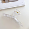 Elegant gold S-shaped metal hair clips with clear acrylic detailing