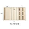 A rectangular plush velvet jewelry storage tray with multiple compartments and a hinged lid.