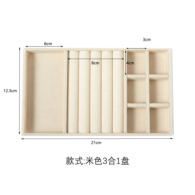 A rectangular plush velvet jewelry storage tray with multiple compartments and a hinged lid.