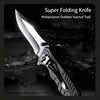 A silver super folding knife with a black handle is shown resting on a dark, textured surface.