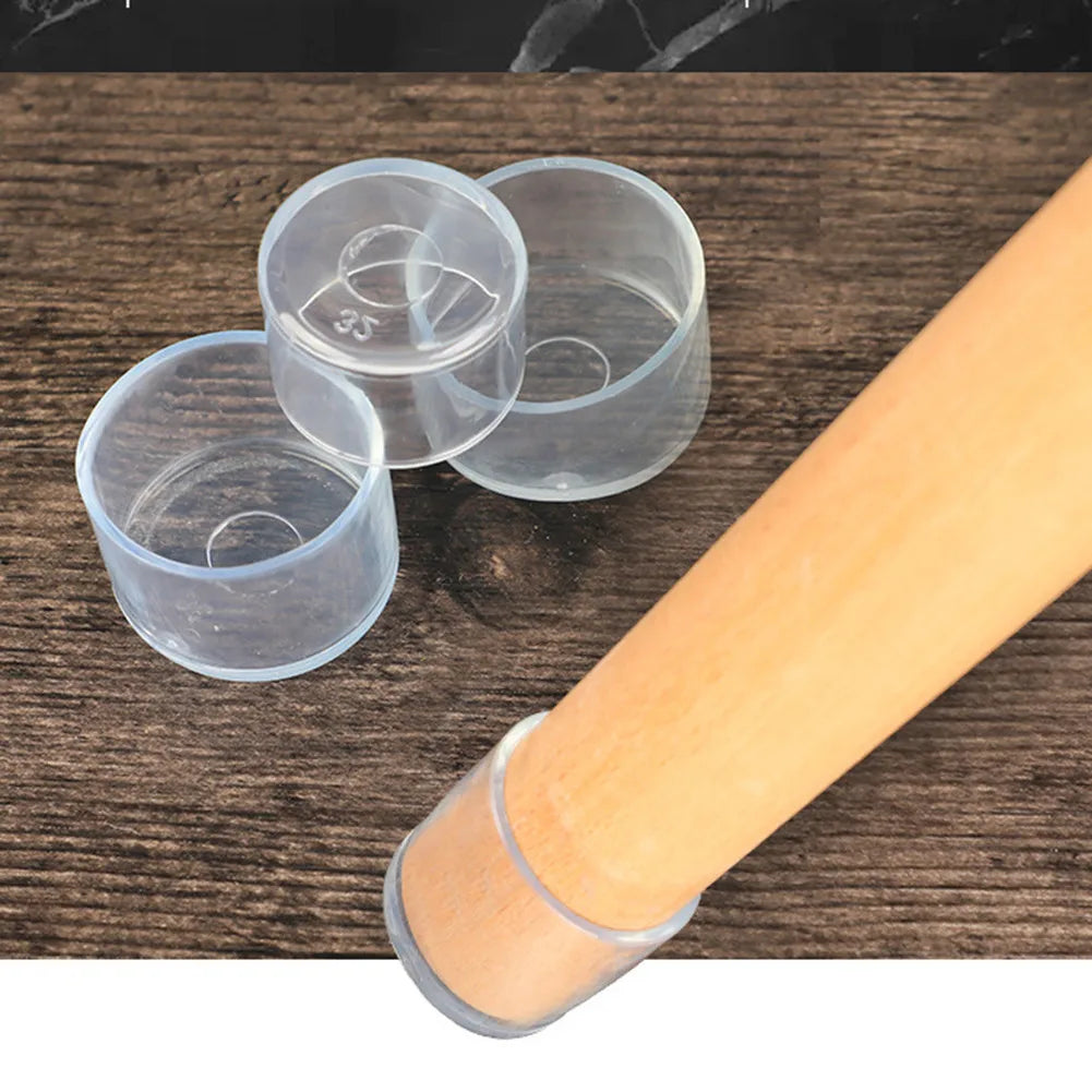Clear plastic foot protectors and a wooden dowel shown on a dark wood surface.