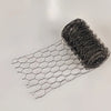 A roll of black chicken wire mesh laid out next to a flat piece of the same material.