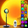 A multi-color LED sunset projector night light with a spherical lens and a control remote, set against an orange background.