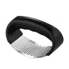 Black manual stainless steel garlic and ginger press with a perforated plate.