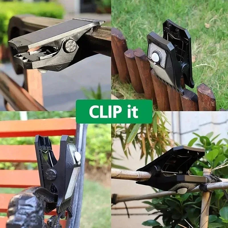 A black solar LED clip-on motion sensing outdoor light is shown attached to a wooden fence.