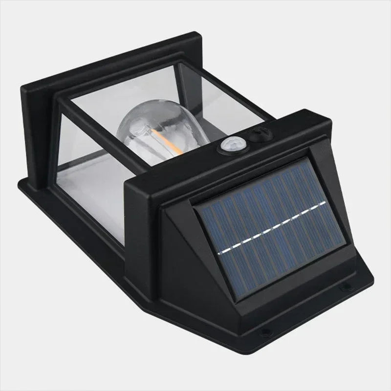 A black solar motion sensor outdoor wall light with a clear glass enclosure and a solar panel mounted on the front.