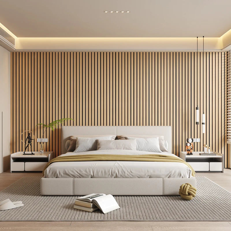 A modern bedroom featuring a beige wall with vertical wood slats and a large bed with white linens.