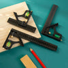 A set of precision measuring tools including a ruler, calipers, and a small green object on a wooden surface.