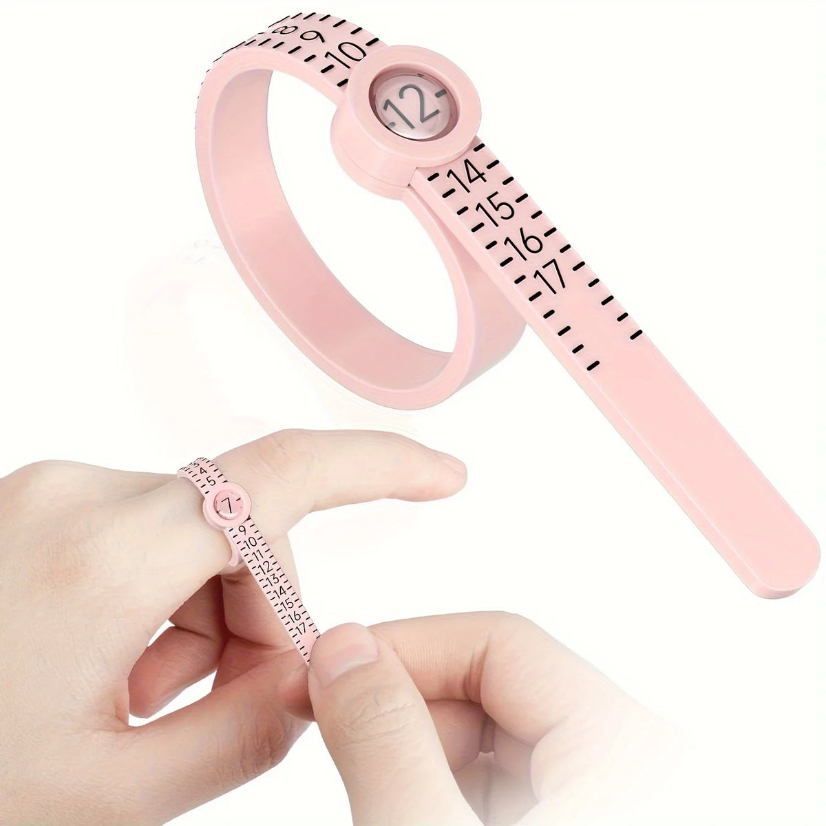 A hand holds a pink precision ring measuring tool with a magnifier, showing the scale and ring size.