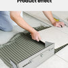 Hands apply mortar to a tile using an adjustable trowel on a floor surface.